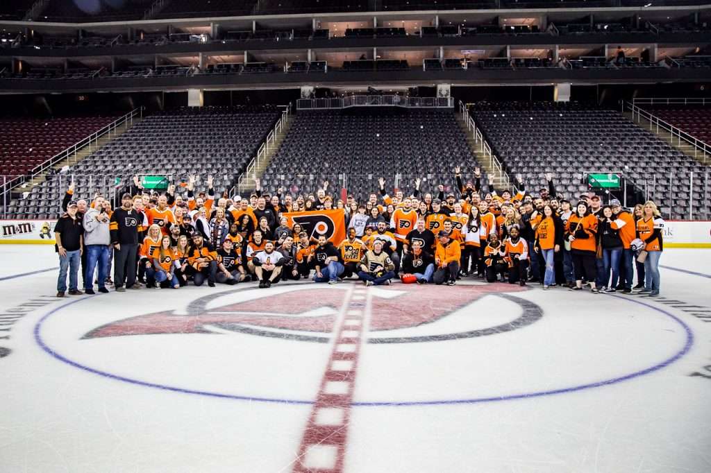 A big group of Philadelphia Flyers posing for a group photo. At center ice of the Prudential Center. This was post game after the Phans of Philly bus trip. They are a traveling fan group
